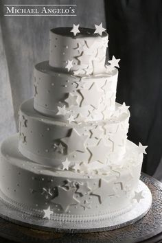 a white wedding cake with stars on it