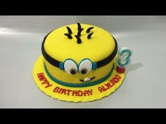 a yellow birthday cake decorated with an emo face and the words happy birthday on it