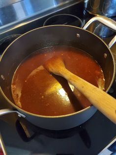 a wooden spoon in a pot on the stove