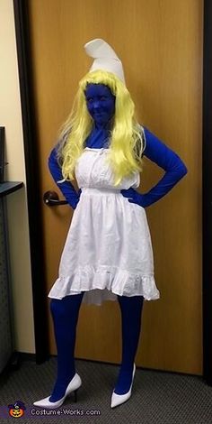 a woman dressed in blue and yellow poses for the camera