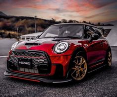 a red and black car parked on the street