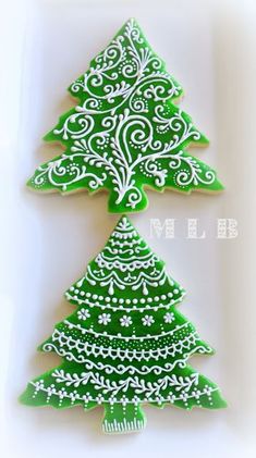 christmas cookies decorated with green and white icing are shown in the shape of trees