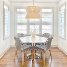 a dining room table with four chairs around it