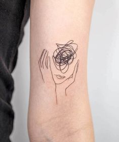 a woman's arm with a black and white line drawing on the left side of her arm