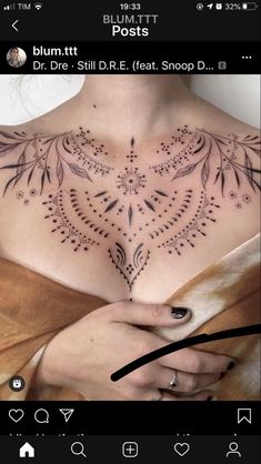 a woman's chest with tattoos on it and an arrow pointing to the right