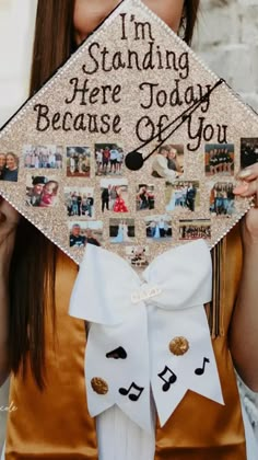 a woman holding up a graduation cap with pictures on it