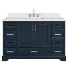 an image of a bathroom vanity with two sinks and gold faucets on it