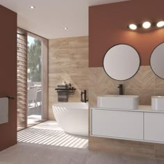 a bathroom with two round mirrors above the sinks and a large tub in front of it