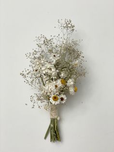 a bouquet of white and yellow flowers on a wall in front of a white background