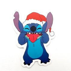 a sticker with a cartoon character wearing a santa hat and holding his hands in the air