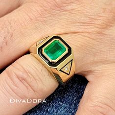 "This one-of-a-kind man's band features a natural Zambian emerald center-stone with a deep rich color, GIA certified 2.38cts. We gave the ring a more unique design by hand-enameling around the center stone as well as around the genuine diamonds set on each side of the ring. Not only that! We can also laser engrave the inside of the ring with any text free of charge. Please insert your message in the \"Add your personalization\" section. Item# EMDBDD09 Metal: 18K Solid Gold CENTER-STONE Center-stone Type: Emerald Emerald weight: 2.38ct  (Natural Zambian) Center Stone dimensions: 8.7mm x 10.6mm Diamond Count: 2 genuine diamonds  Diamonds Total Weight: 0.14 cts RING DIMENSIONS: Top of the ring: 12mmx14mm Height from the finger: 6.5mm ----------------------------------------------------- ✨ CUS Luxury Fine Jewelry Emerald Ring For Men, Mens Gemstone Rings Unique, Gemstone Rings Unique, Mens Gemstone Rings, Zambian Emerald, Mens Band, Emerald Ring, Solid Metal, Black Enamel