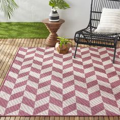 Update your indoor/outdoor space with the Nicole Miller New York Patio Country Calla rug by Home Dynamix. The eye-catching, functional rug showcases geometric shapes that will add a modern chic accent to your patio, deck or porch and comfort underfoot. The easy-care rug is durable and won't scratch your deck surface. It's UV fade and weather resistant. Ideal for indoor, high traffic areas such as the kitchen, playroom, and mudroom. Nicole Miller 6 X 9 (ft) Pink Indoor/Outdoor Area Rug | 2A-4554-200 Rugs And Mats, Pink Ivory, Stylish Rugs, Garden Items, Patio Rugs, Geometric Area Rug, Outdoor Area Rug, Indoor Outdoor Area Rugs, Nicole Miller