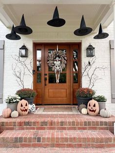 two pumpkins are sitting on the front steps