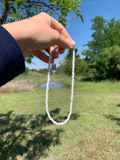 Cute white bead necklace for the beach, lake, or summer. White Crystal Necklaces With Tiny Beads, Minimalist White Beaded Necklaces For Everyday, Everyday White Single Strand Beaded Necklace, Minimalist White Beaded Necklace For Everyday, Minimalist Everyday White Beaded Necklaces, Everyday White Single Strand Necklace, White Handmade Beads, White Beaded Chain Necklace For Everyday, White Hand-strung Crystal Necklace For Gift