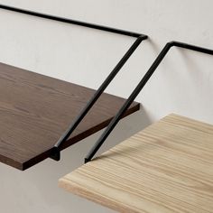 two wooden shelves with metal brackets on them