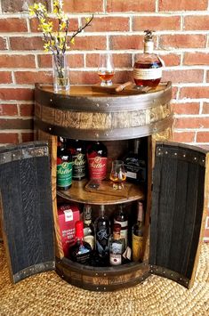 a wine barrel table with liquor bottles on it