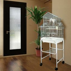 a bird cage sitting on top of a table next to a door