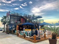 an outdoor restaurant with tables and umbrellas