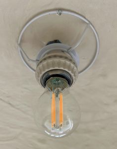 a light fixture with two yellow candles in it