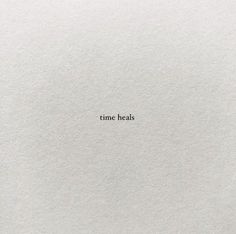 the word time heals written in white paper