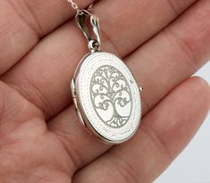 "Also available in gold plated/rose gold plated over sterling silver. This elegant customized oval locket will help you keep the memories of your loved ones afresh: 1. One shining, highly polished sterling silver locket. (19 x 26 mm, about the size of a quarter, 4.6 grams). Its front has an etched decorative border. Its back is plain. Both sides can be custom engraved with initial, text or simple graphics.  2. There are two photo slots. Photo insertion service is available for $14 each photo (pricing reflected in your pulldown option. If you select \" ... 1/2 photo\", please send your locket photos by attaching them to an ETSY conversation to me. 3. a sterling silver or gold filled cross pendant     Upgrade is also available:     https://www.etsy.com/listing/736367470 4. an optional custom Elegant Oval Locket Necklace As A Gift, Elegant Oval Locket Necklace For Gift, Oval Charms Jewelry For Keepsake, Keepsake Oval Charms Jewelry, Oval Keepsake Jewelry With Charms, Oval Keepsake Jewelry Charms, Classic Locket Necklace With Charms For Gift, Elegant Oval Locket Necklace For Personalized Gift, Elegant Medallion Locket Necklace For Personalized Gift