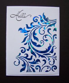 a white card with blue swirls and the word hello written in cursive writing