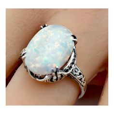 an opalite ring with filigrees on it