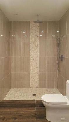 a bathroom with tiled walls and wooden floors