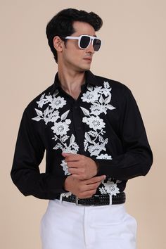 Black shirt with floral applique embroidery and cuff sleeves.
Component: 1
Pattern: Embroidered
Type Of Work: Applique
Neckline: Shirt Collar
Sleeve Type: Cuff Sleeves
Fabric: Cotton
Color: Black
Other Details: 
Note: Pant and belt worn by the model is not for sale
Occasion: Party - Aza Fashions Fitted Cotton Shirt With Embroidered Cuffs, Formal Fitted Tops With Embroidered Cuffs, Formal Long Sleeve Tops With Embroidered Cuffs, Designer Embroidered Long Sleeve Shirt, Designer Long Sleeve Embroidered Shirt, Black Embroidered Shirt For Formal Occasions, Formal Black Embroidered Shirt, Spring Formal Embroidered Shirt, Fitted Long Sleeve Shirt With Embroidered Cuffs