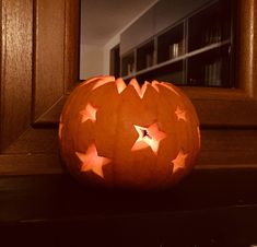 a carved pumpkin sitting on top of a window sill