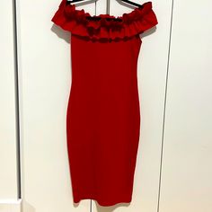 a red dress hanging on a white door