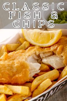 fish and chips in a basket with lemon wedges