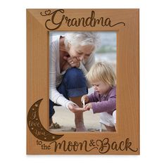 a wooden frame with an image of a mother and her child on the moon, saying'i love you to the moon and back '