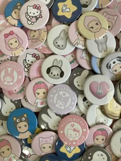 a pile of hello kitty buttons sitting on top of each other