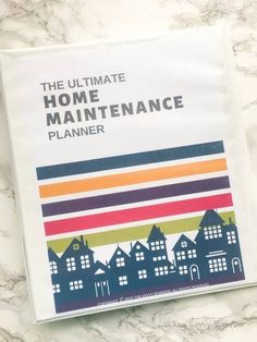 the ultimate home maintenance planner on a marble surface