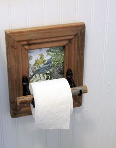 a toilet paper roll hanging from a wooden frame