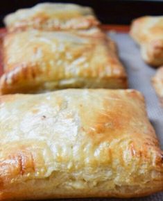 four pastries sitting on top of a baking sheet