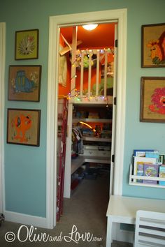 an open door leading into a room with pictures on the wall