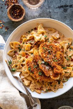 a white bowl filled with pasta and meat