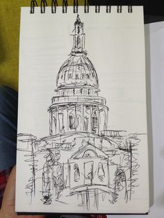 a drawing of the capital building in washington, d c is shown on a notepad