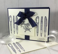 a handmade thank you card with pens and ribbons