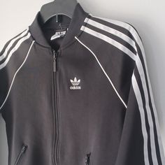 A Phenomenal Deal On A New Super Cute Adidas Classic Three Stripe Jacket. Activewear, Casual. Outdoor Activities. May Be Perfect For A Bonfire, Hiking, Camping, Sports Game, Outdoor Events, Cool Evenings, Festival, Etc. Sport With Your Favorite Jeans, Pants Or Shorts To Concert, Bowling, Karaoke Or An Outing. Casual, Trendy, Street-Wear (Streetwear), Preppy Style. Wear Traveling, Shopping Or Spending Time With Friends. Size ... 2xs (See Photos, Which Include Tape Measurements) Color ... Black An Sportswear Track Jacket With Zipper For Streetwear, Casual Track Jacket With Zip Fly For Streetwear, Black Casual Track Jacket With Zipper, Casual Black Track Jacket With Zipper, Casual Black Track Jacket With Zipper Closure, Black Track Jacket With Zipper Closure, Sporty Winter Track Jacket With Zipper Closure, Casual Black Track Jacket With Ykk Zipper, Trendy Sports Track Jacket With Pockets