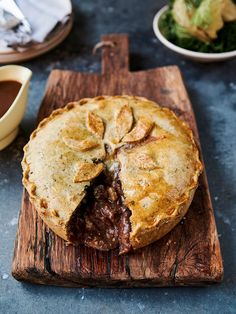 a piece of pie sitting on top of a wooden cutting board