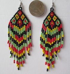 two pairs of beaded earrings are shown next to a penny