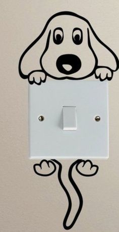 a white light switch with a dog drawn on it