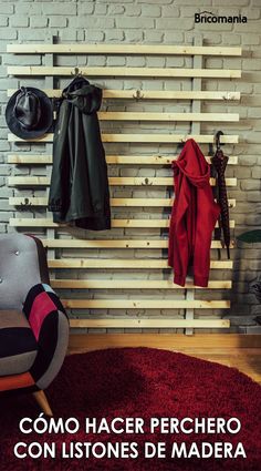 a chair and coat rack in front of a brick wall with clothes hanging on it