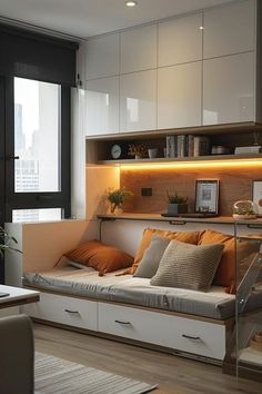 a living room filled with furniture next to a window covered in light colored pillows and blankets