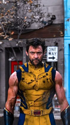 a man dressed as wolverine stands in front of a building