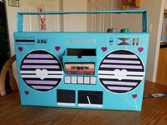 an old school radio box with hearts and arrows painted on the side, sitting on a wooden table