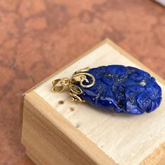 Estate/ vintage 14KT yellow gold genuine, blue lapis lazuli omega pendant. Beautiful, dark cobalt blue lapis with golden flecks. Pendant measures: 1.5” x .75” Bail approx. 2mm wide Classic floral carving on lapis Excellent estate condition Weight: 8.5 grams Made in Italy & stamped 14K Chain not included Luxury Blue Carved Jewelry, Luxury Carved Blue Jewelry, Elegant Carved Blue Jewelry, Elegant Blue Carved Jewelry, Luxury Oval Lapis Lazuli Jewelry, Artisan Gold Lapis Lazuli Jewelry, Blue Engraved Amulet Style Jewelry, Blue Engraved Amulet Jewelry, Artisan Gold Jewelry With Lapis Lazuli